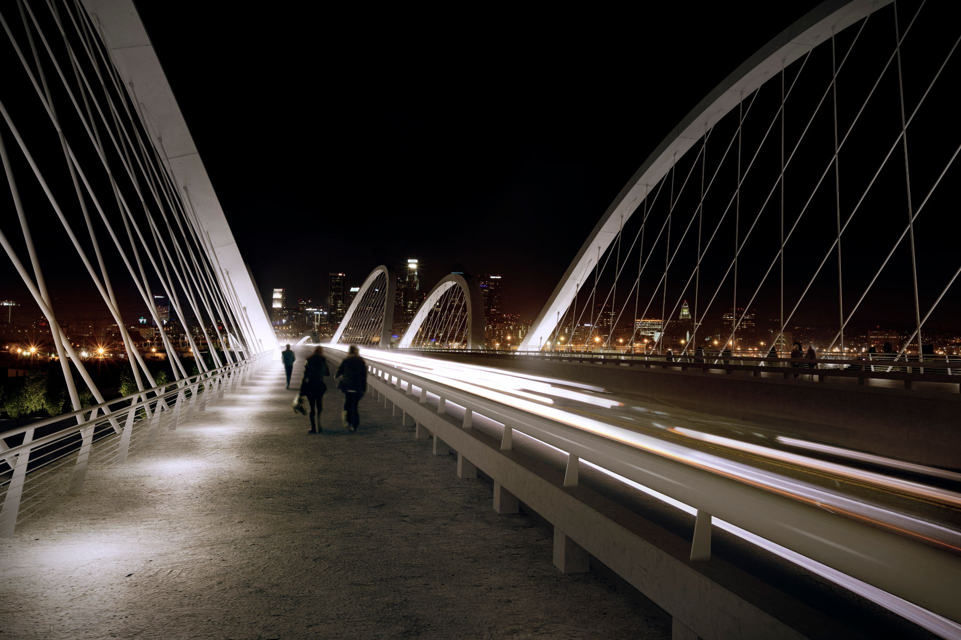 3D rendering on the Sixth Street Viaduct deck at night, pedestrians walking the lit walkway between the canted cable-stayed arches as traffic streaks past toward the Downtown Los Angeles skyline.